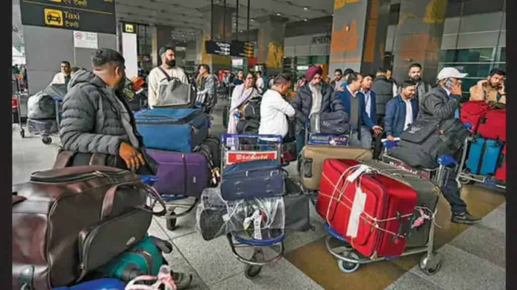 Passengers waiting to retrieve their baggage